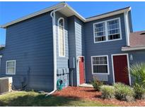 Two-story home featuring a freshly painted exterior and well-manicured landscaping at 206 Orchid Dr, Davenport, FL 33897