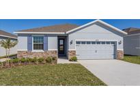 Charming one-story home with stone accents, light blue exterior and well-maintained landscaping at 5017 Balsam Falls Rd, Deland, FL 32724