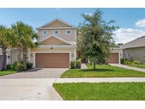 Charming two-story home featuring a three-car garage, well-maintained lawn, and inviting curb appeal at 1539 Osprey View Dr, Apopka, FL 32703