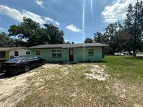 Quaint one-story home with a fresh exterior paint job and a well-manicured lawn, perfect for first-time buyers at 102 Harold St, Leesburg, FL 34748