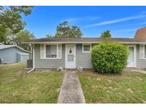 Charming home featuring a well-manicured lawn and inviting front entrance with cute cat statues at 10301 Us Highway 27 # 187, Clermont, FL 34711