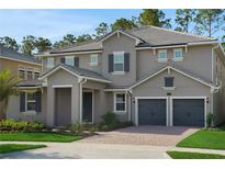 Charming two-story home featuring a three-car garage and well-manicured landscaping at 14249 Crest Palm Ave, Windermere, FL 34786