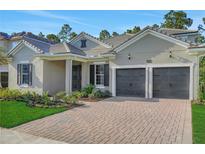 Beautiful single-story home featuring a brick driveway and a two-car garage at 14285 Crest Palm Ave, Windermere, FL 34786