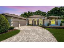 Beautiful single-Gathering home with well-manicured landscaping and an elegant circular driveway at 16951 Florence View Dr, Montverde, FL 34756