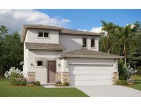 Charming two-story home with a neutral color scheme, stone accents and an attached two-car garage at 2004 Sunshine Peak Dr, Minneola, FL 34715