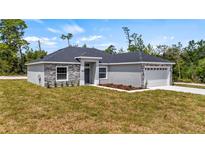 Attractive single-Gathering home with stone facade and well-maintained lawn at 24912 Jefferson St, Astatula, FL 34705