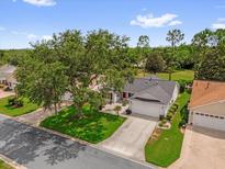 Charming single-story home with well-manicured lawn and mature landscaping at 2712 Plainridge Loop, The Villages, FL 32162