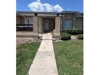 Charming single-story home with inviting entrance and manicured lawn at 3306 Sandy Shore Ln, Kissimmee, FL 34743