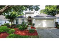 Charming single-story home with well-maintained lawn, landscape beds, and attached two-car garage at 3718 Westerham Dr, Clermont, FL 34711