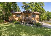 Charming brick home with a well-maintained lawn and inviting front porch, perfect for enjoying the outdoors at 5581 Sw 197Th Ter, Dunnellon, FL 34431