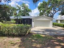 Charming single-story home with a well-maintained lawn and an attached two-car garage at 7378 Ne 49Th Ln, Wildwood, FL 34785