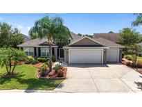Charming home with a three-car garage and mature landscaping at 1910 Quiet Oak Ct, The Villages, FL 32162