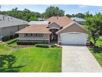 Charming single-story home showcasing a well-manicured lawn and a two-car garage at 3257 Baltic Sea Blvd, Tavares, FL 32778