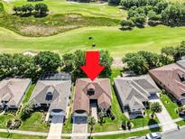 Aerial view of a single-Gathering home on a golf course with a mature landscaped yard and a screened-in pool at 3519 Arlington Ridge Blvd, Leesburg, FL 34748