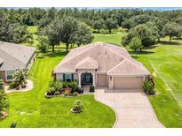 Beautiful single-story home on a lush lot featuring a three-car garage and well-manicured landscaping at 3809 Arlington Ridge Blvd, Leesburg, FL 34748
