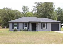 Charming single-story home with gray exterior, black shutters, and well-maintained lawn at 41 Dogwood Loop, Ocala, FL 34472