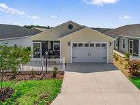 Charming single-story home featuring a two-car garage, screened porch, and well-maintained landscaping at 6301 Whittle Ct, The Villages, FL 32163