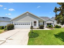 Charming home with a two-car garage and well-manicured lawn at 654 Fayette Ct, The Villages, FL 32162