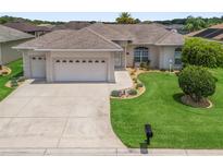 Charming single-story home featuring a well-maintained lawn and a three-car garage at 11019 Se 170Th Lane Rd, Summerfield, FL 34491