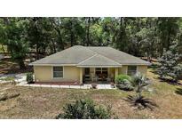 Charming single-story home with a cozy front porch and well-maintained landscaping at 11495 Se 71St Terrace Rd, Morriston, FL 32668