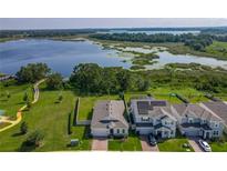 Beautiful aerial view of homes near a lake and boardwalk trails on a sunny day at 124 Juno Dr, Groveland, FL 34736