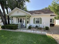 Charming home featuring a quaint front porch, manicured lawn, and lush landscaping with stone walkway at 1339 Orchid Ave, Winter Park, FL 32789