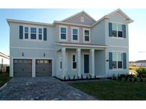 Charming two-story home featuring a two-car garage, a beautifully landscaped yard, and classic shutters at 1845 Sunshine Peak Dr, Minneola, FL 34715