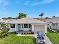 Charming single-story home featuring a well-maintained lawn and an attached one-car garage at 2235 Harbor Town Ln, Lakeland, FL 33810