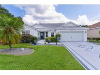 Charming single-story home with a well-manicured lawn, a decorative driveway, and a two-car garage at 2738 Morven Park Way, The Villages, FL 32162