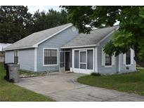 Charming single-story home with blue siding, screened porch, and well-maintained landscaping at 610 Swallow Ct, Apopka, FL 32712