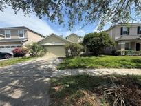 Charming single-Gathering home featuring an attached garage and a well-maintained front yard at 1209 Cathcart Cir, Sanford, FL 32771