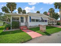Charming single-story home with well-maintained lawn and lush landscaping at 124A Shady Ln, Eustis, FL 32726