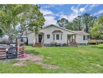 A charming home with a large backyard and mature trees provides a serene outdoor living space at 21320 Paradise Way, Eustis, FL 32736