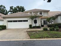 Charming home featuring a two-car garage and a well-maintained landscaped yard at 2450 Sweetwater Country Club Dr, Apopka, FL 32712