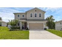 Charming two-story home featuring a spacious two-car garage and a well-maintained lawn at 2532 Autumn Stream Dr, Leesburg, FL 34748