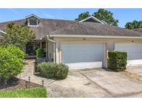 Charming townhome with attached garage, tidy landscaping, and a welcoming facade at 264 Juniper Way, Tavares, FL 32778