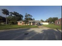 Charming single-story brick home with a well-maintained lawn and mature landscaping at 48 Pinehurst Cir, Ormond Beach, FL 32174