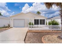 Charming single-story home with a well-maintained front yard, concrete driveway, and attached garage at 9321 Se 172Nd Augusta Ln, The Villages, FL 32162