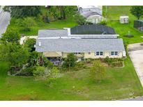 Charming home featuring a screened-in pool, mature landscaping, and a well-maintained lawn at 101 Lakeshore Blvd, St Cloud, FL 34769