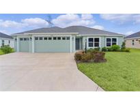 Charming one-story home featuring a two-car garage and well-maintained landscaping at 1449 Jeremy Cir, The Villages, FL 34762