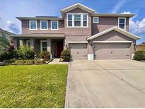 Charming two-story home with landscaped front yard and a two-car garage offers curb appeal at 1861 Remembrance Ave, St Cloud, FL 34769