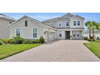 Stunning two-story home with brick driveway, attached two-car garage and meticulously maintained landscaping at 2147 Timber Creek Ln, Clermont, FL 34715