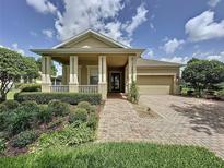 Charming single-Gathering home featuring a well-manicured lawn and a welcoming brick pathway to the front door at 243 Bayou Bend Rd, Groveland, FL 34736