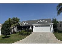 Well-maintained single-story home with landscaped front yard, beautiful driveway, and a two-car garage at 2530 Hanlon Ter, The Villages, FL 32162