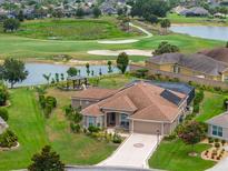 Beautiful home with golf course and pond views, screened lanai, and lush landscaping at 3097 Bureau Path, The Villages, FL 32163
