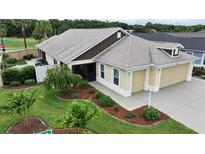 Home with a three car garage and well maintained landscaping at 3466 Smedley Rd, The Villages, FL 32163