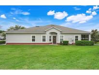 This backyard features a well-manicured lawn and neatly trimmed hedges surrounding the house at 3547 Fairwaters Ct # F, Clermont, FL 34711