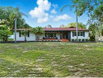Charming single-story home featuring mature landscaping, bright exterior paint, and updated architectural details at 9269 Silver Lake Dr, Leesburg, FL 34788
