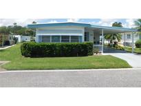 Charming single-story home with well-manicured lawn and carport in a tranquil community at 114 Azalea Trl, Leesburg, FL 34748