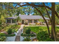 Charming single-story home featuring a landscaped front yard with lush greenery and a welcoming entrance at 2214 Dogwood Cir, Mount Dora, FL 32757
